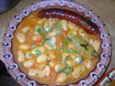 a plate of food with a sausage and macaroni and cheese at Guest House Todorini kashti in Koprivshtitsa