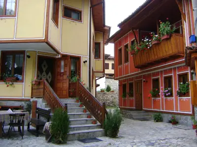 a building with stairs and flower boxes on it at Guest House Todorini kashti in Koprivshtitsa