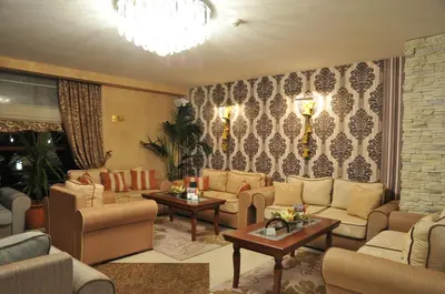 a living room with couches and tables at Hotel Park Bachinovo in Blagoevgrad