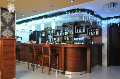a bar in a restaurant with stools at Hotel Park Bachinovo in Blagoevgrad