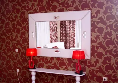 a mirror on a wall in a room at Hotel Park Bachinovo in Blagoevgrad