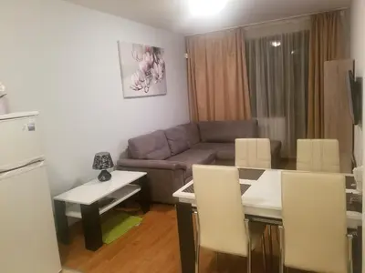 a living room with a couch and a table at Belveder Holiday Club Private in Bansko
