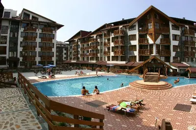 a large swimming pool in front of a hotel at Belveder Holiday Club Private in Bansko