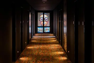 a hallway with a painting of a woman on the wall at Rila Hotel Sofia in Sofia