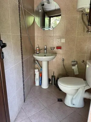 a bathroom with a sink and a toilet and a mirror at Вила Мерджан in Sarnitsa