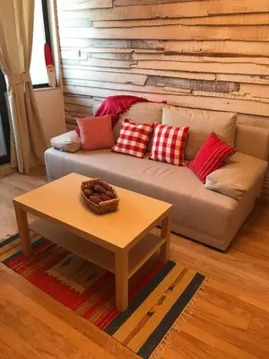 a living room with a couch and a coffee table at Papa Moose Pamporovo in Pamporovo