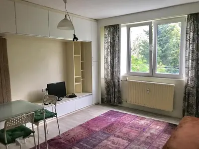 a living room with a table and a window at Modern Studio 20 Meters from Mladost 1 Metro Station in Sofia
