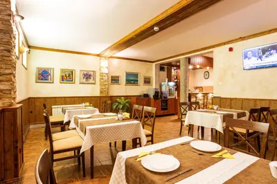 a restaurant with tables and chairs in a room at Hotel Villa Boyana - Free Parking in Sofia