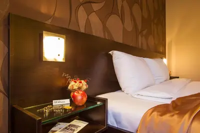 a hotel room with a bed and a table with a fruit on it at Hotel Villa Boyana - Free Parking in Sofia