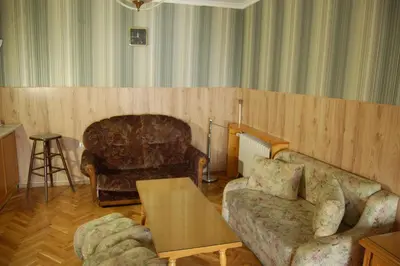 a living room with a couch and a table at Stivan Iskar Hotel in Sofia