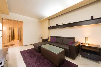 a living room with a couch and a table at City Apartments in Sofia