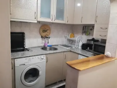 a kitchen with a washing machine and a sink at Apartment Beti in Devin