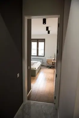 a view of a bedroom from a hallway with a bed at Apartment Rotonda in Sofia