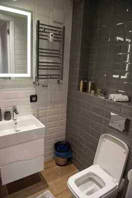 a bathroom with a white toilet and a sink at Apartment Rotonda in Sofia