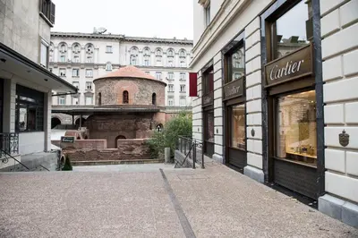 an empty street with a building in the background at Apartment Rotonda in Sofia