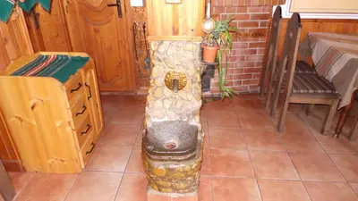 a water fountain in the middle of a room at Chuchura Family Hotel in Koprivshtitsa