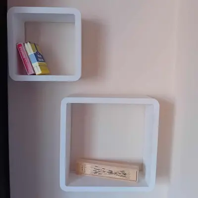 a white box with a book on a wall at Katy's studio in Bansko