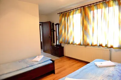 a room with two beds and a window at Guest House Mavrudieva in Koprivshtitsa