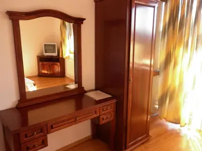 a bathroom with a mirror and a wooden dresser at Guest House Mavrudieva in Koprivshtitsa