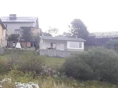 a white house with a garden and a yard with bushes at Къща за гости Чала in Chala
