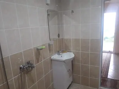 a bathroom with a shower with a toilet and a sink at Къща за гости Чала in Chala