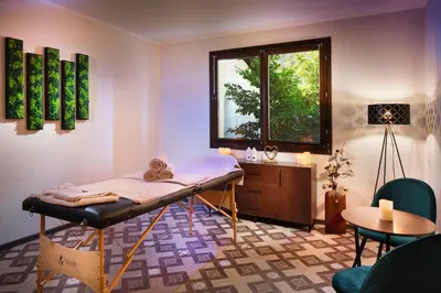 a room with a bed and a table and a window at Alfaresort Palace Chiflika in Chiflik