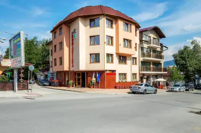 a building on the corner of a street at Family Hotel Romantika in Velingrad