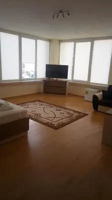 a large room with a rug on a wooden floor at Hotel Lago Peshtera in Peshtera