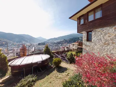 a house with a large boat on the side of it at Rodope Nook Guest house in Chepelare