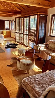 a living room with a couch and a table at Rodope Nook Guest house in Chepelare