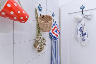 a white tiled wall with a basket and towels at Shik & Chic One Bedroom Central Apartment Graf Ignatiev x Shishman Corner by Flat Mаnager in Sofia