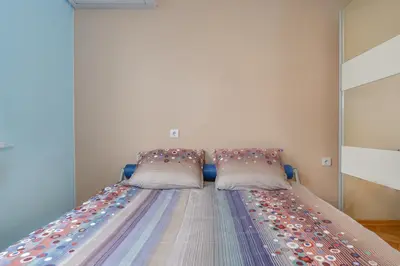 a bed with two pillows on it in a room at Comfortable One Bedroom Apartment in a Lively Area | Zona B5 | Russian Square in Sofia