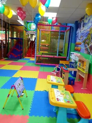 a room with a playground with colorful floors and play equipment at Комплекс Кремен in Blagoevgrad