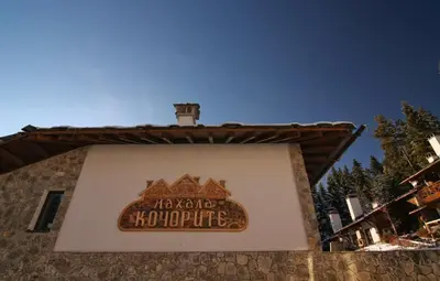 a sign on the side of a building at Holiday Village Kochorite in Pamporovo