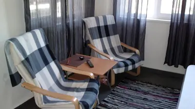 two chairs and a wooden table in a room at Avel Guest House in Sofia