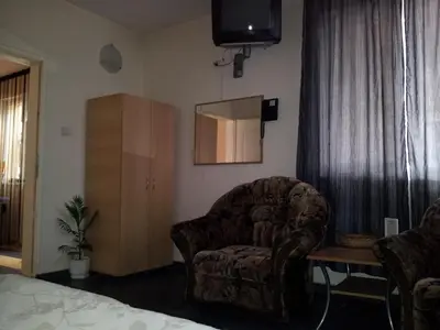 a living room with a chair and a television at Avel Guest House in Sofia