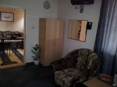 a living room with a chair and a mirror at Avel Guest House in Sofia