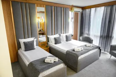 a hotel room with two beds and a window at Park Hotel Plovdiv in Plovdiv