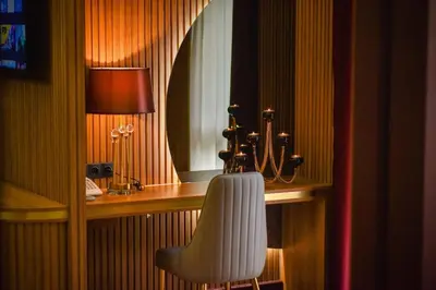 a room with a desk with a chair and a mirror at Park Hotel Plovdiv in Plovdiv