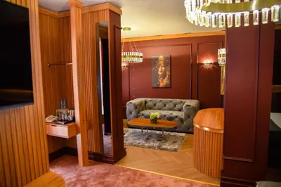 a living room with a couch and a table at Park Hotel Plovdiv in Plovdiv