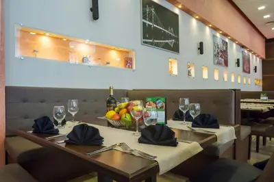 a dining room with a table with wine glasses at Terra Hotel in Bansko