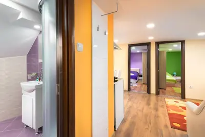 a bathroom with a sink and a mirror at Serdika Round Tower Apartments in Sofia