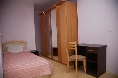 a bedroom with a bed and a desk and a chair at BLOCK 531 ApartHouse BLOCK 533 in Sofia