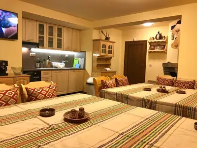 a room with two beds and a kitchen at Vila Rila Samokov in Samokov