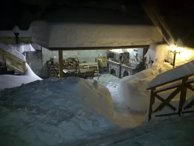 a room covered in snow with a table and chairs at Vila Rila Samokov in Samokov