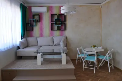 a living room with a couch and a table at Sofia Central Pretty Apartment in Sofia