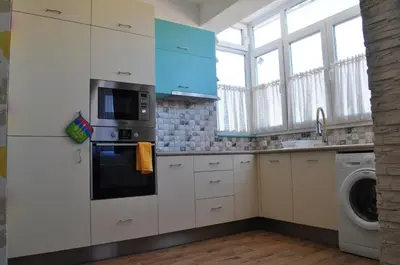 a kitchen with white cabinets and a washer and dryer at Sofia Central Pretty Apartment in Sofia