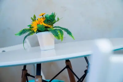 a vase of flowers sitting on a table at Sofia Central Pretty Apartment in Sofia