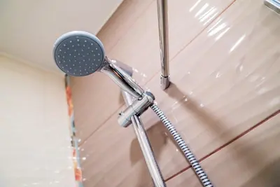 a shower head hanging from the ceiling in a room at Sofia Central Pretty Apartment in Sofia