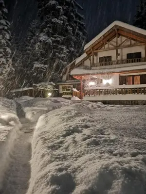 a ski lodge with a pile of snow in front of it at Saint George Borovets Hotel in Borovets